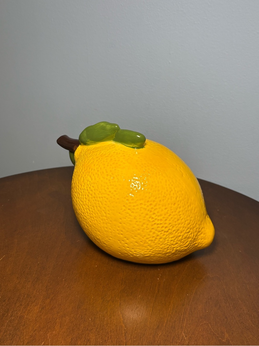 Glossy Ceramic Lemon Accent with Green Leaves